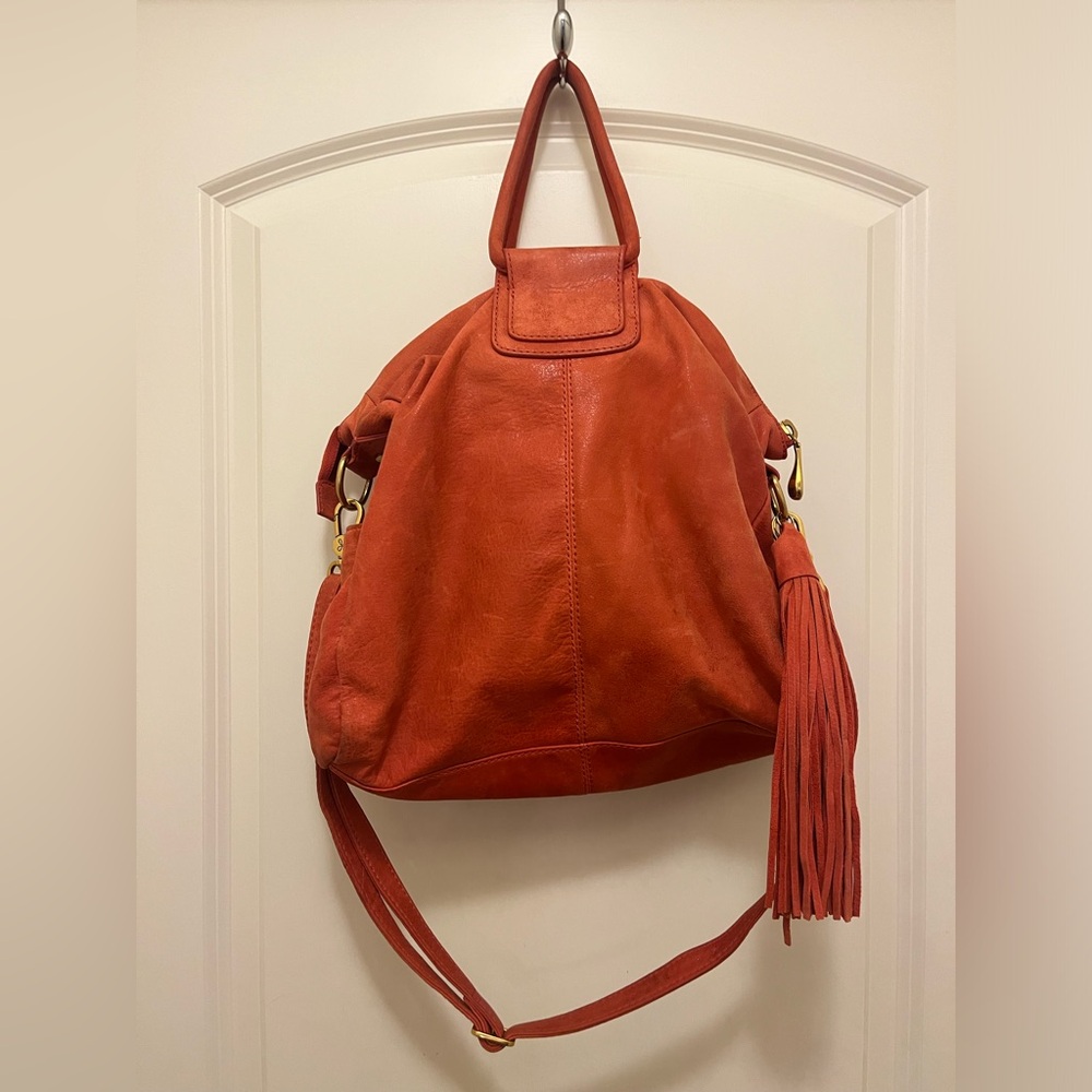 Lava colored leather hobo bag with a tassel. Perfect for summer and fall.